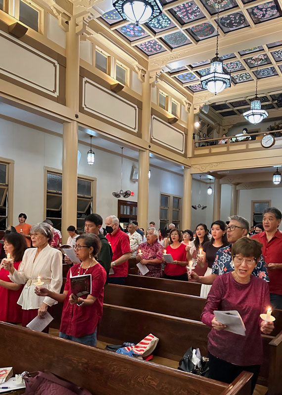 Congregation with candles at Christmas Eve service